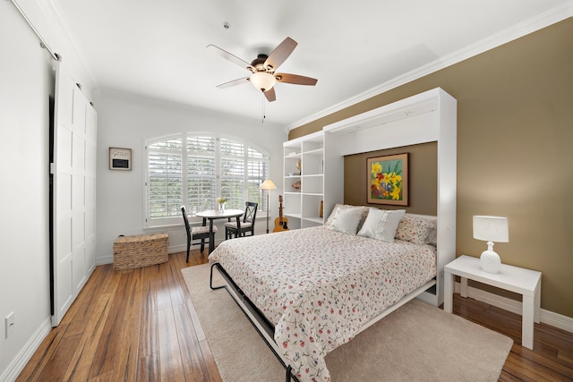 bedroom featuring hardwood / wood-style floors, ceiling fan, and crown molding