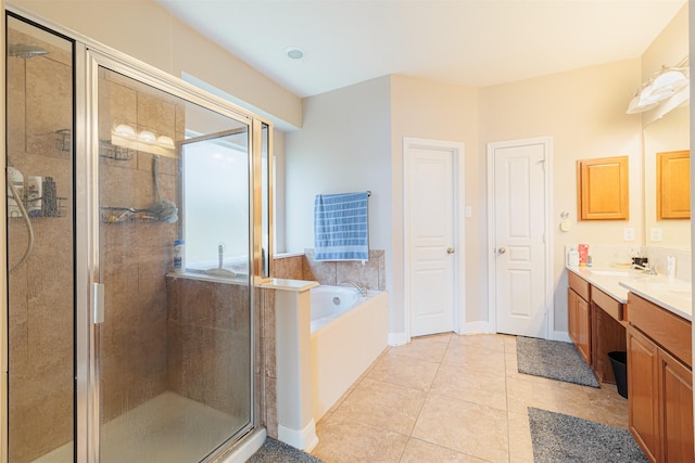 bathroom featuring tile patterned flooring, shower with separate bathtub, and vanity