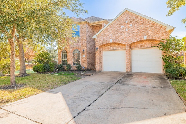 view of front facade with a front yard and a garage