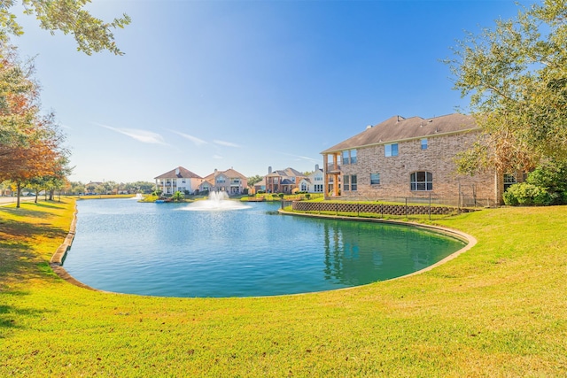 exterior space featuring a water view and a lawn