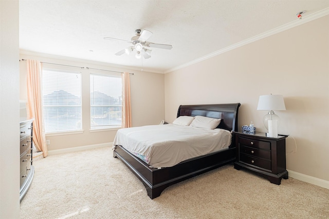 carpeted bedroom featuring ceiling fan and ornamental molding