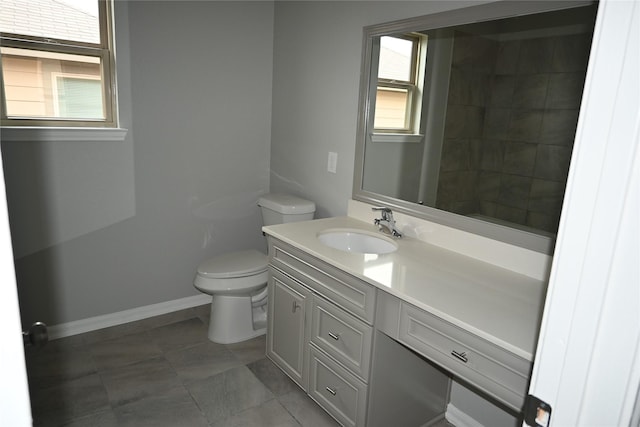 bathroom featuring tile patterned flooring, vanity, and toilet