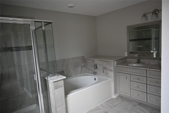 bathroom with plus walk in shower, vanity, and tile patterned flooring