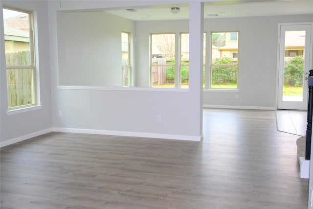 spare room with hardwood / wood-style floors and a healthy amount of sunlight