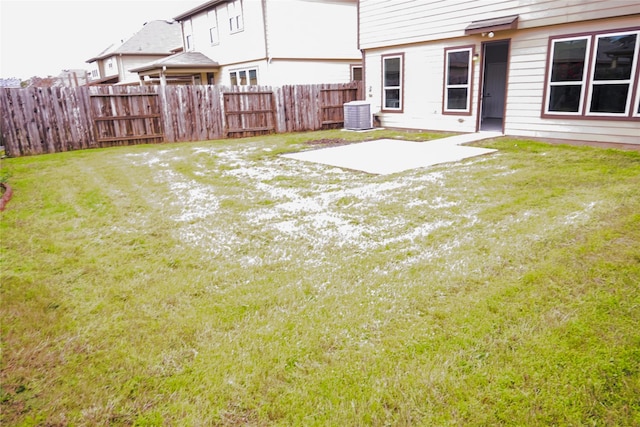 view of yard featuring central air condition unit and a patio