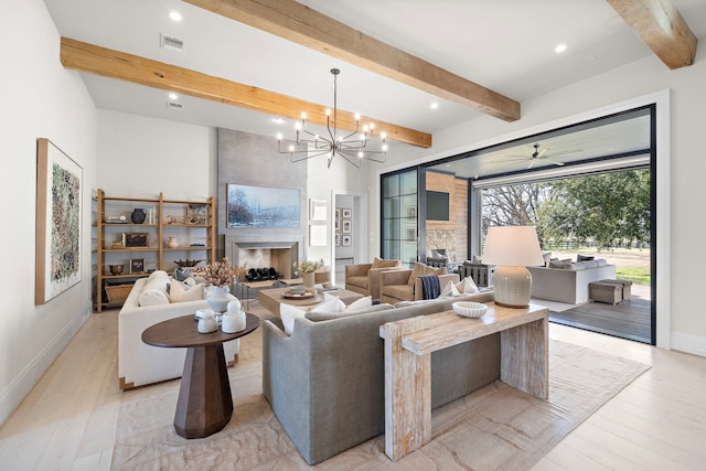 living room featuring light hardwood / wood-style flooring, beam ceiling, and a fireplace