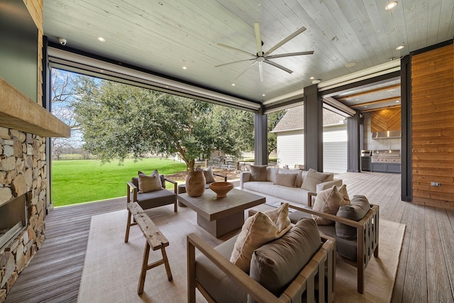 exterior space featuring ceiling fan, outdoor lounge area, and a wooden deck