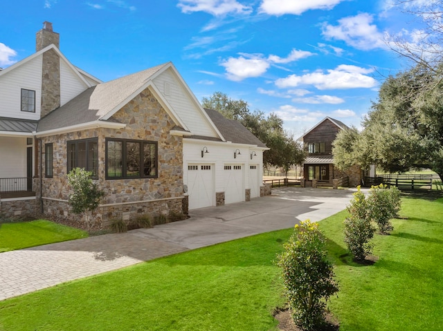 view of side of home with a garage and a lawn