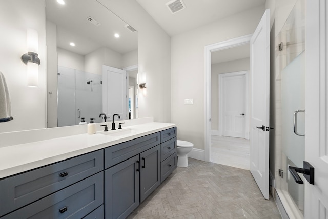 bathroom with toilet, walk in shower, and vanity