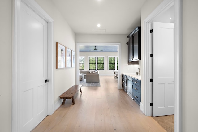 hallway with light hardwood / wood-style flooring