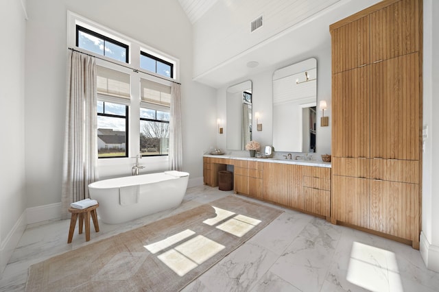 bathroom featuring a bath, high vaulted ceiling, and vanity