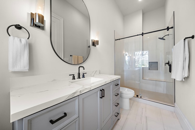 bathroom featuring toilet, vanity, and walk in shower