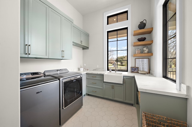 washroom with sink, separate washer and dryer, cabinets, and light tile patterned flooring