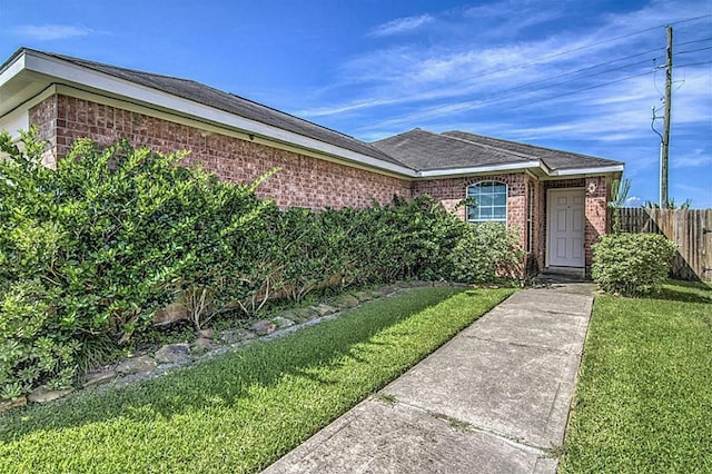 doorway to property featuring a lawn