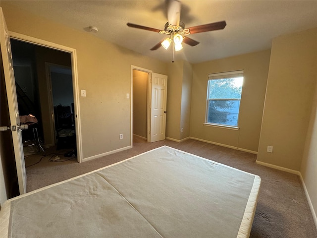 unfurnished bedroom featuring carpet flooring and ceiling fan