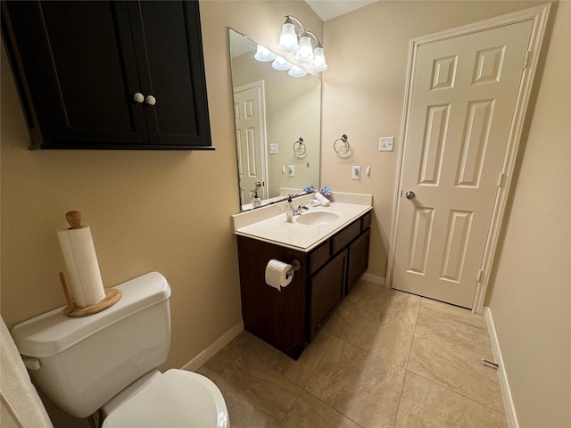 bathroom featuring tile patterned flooring, vanity, and toilet