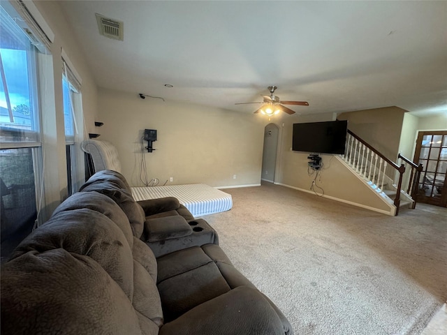 carpeted living room featuring ceiling fan