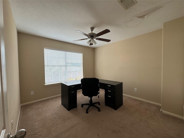 unfurnished office with carpet flooring and ceiling fan