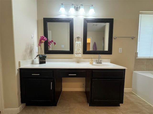 bathroom featuring tile patterned floors, a bathtub, and vanity