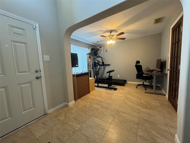 interior space with ceiling fan