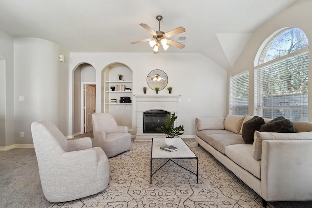 living room featuring ceiling fan, built in features, and light carpet