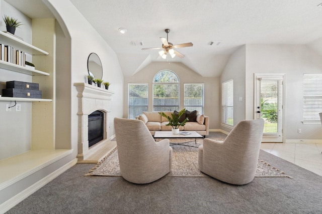 living room featuring vaulted ceiling, ceiling fan, light tile patterned floors, and plenty of natural light