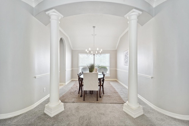 dining room with carpet flooring, an inviting chandelier, ornamental molding, and vaulted ceiling