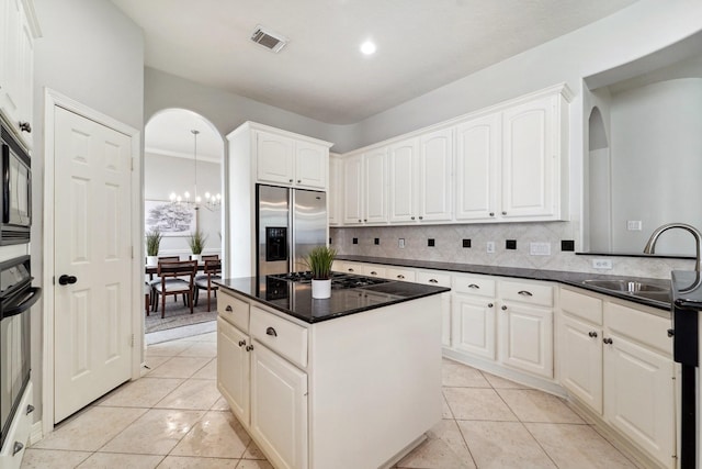 kitchen with stainless steel appliances, white cabinetry, and sink