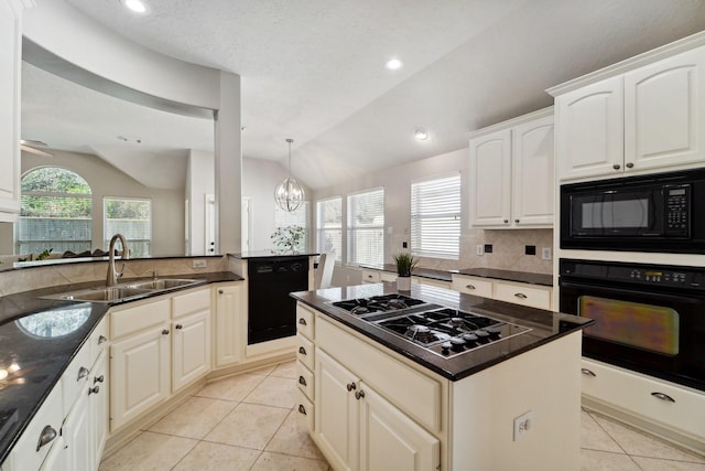 kitchen featuring kitchen peninsula, vaulted ceiling, a notable chandelier, black appliances, and sink