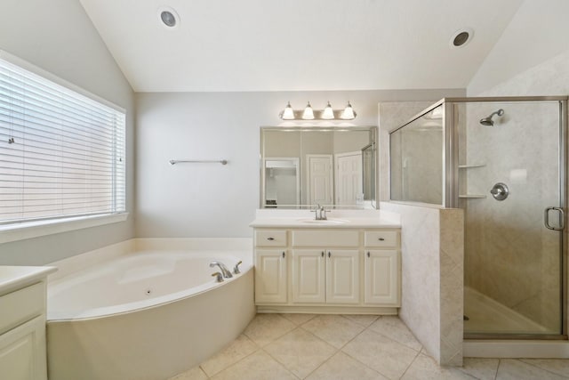 bathroom with tile patterned flooring, lofted ceiling, and vanity