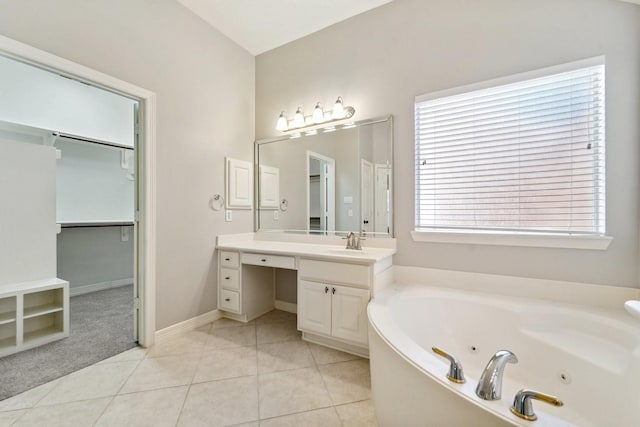 bathroom featuring tile patterned floors, vanity, and a bathing tub