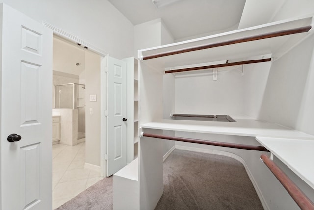 spacious closet with light tile patterned floors