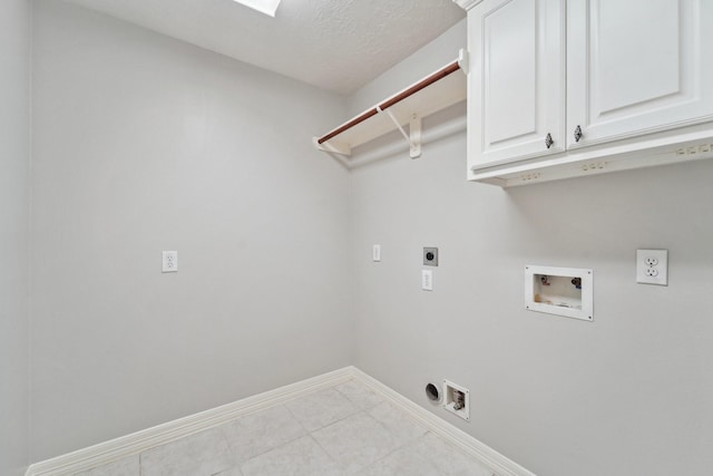 laundry area with a textured ceiling, electric dryer hookup, hookup for a washing machine, and cabinets