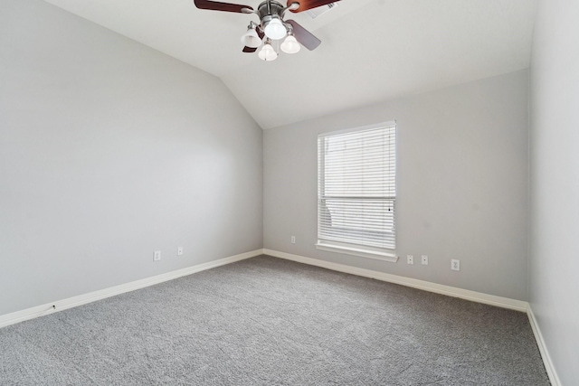 empty room featuring lofted ceiling, carpet floors, and ceiling fan