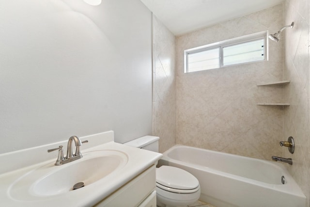 full bathroom with toilet, vanity, and tiled shower / bath combo