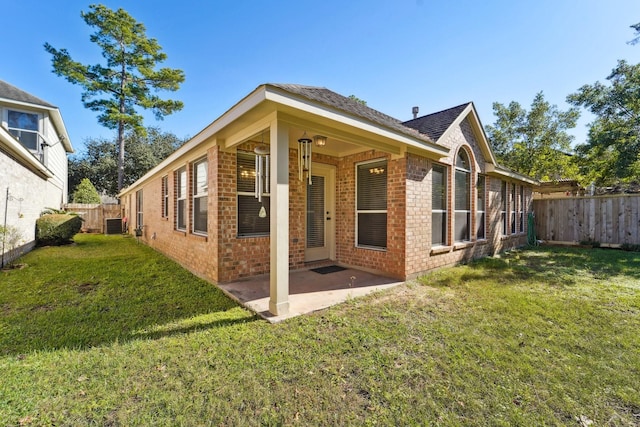 back of property featuring a patio area, central AC unit, and a lawn