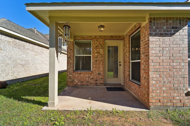 entrance to property featuring a patio