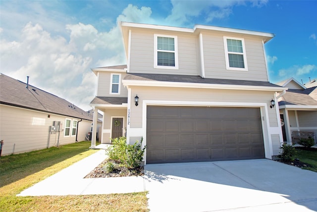 view of front of property with a garage and a front yard