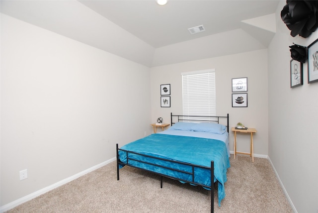 bedroom with carpet floors and lofted ceiling