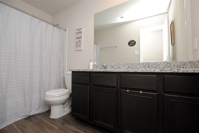 bathroom with hardwood / wood-style floors, vanity, and toilet