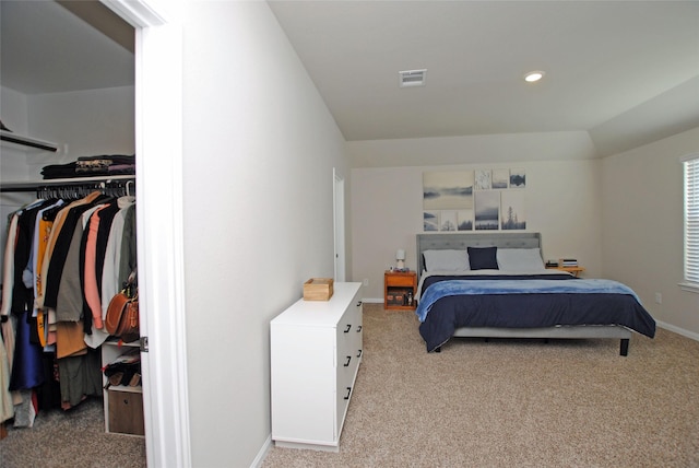 bedroom with light carpet and a closet