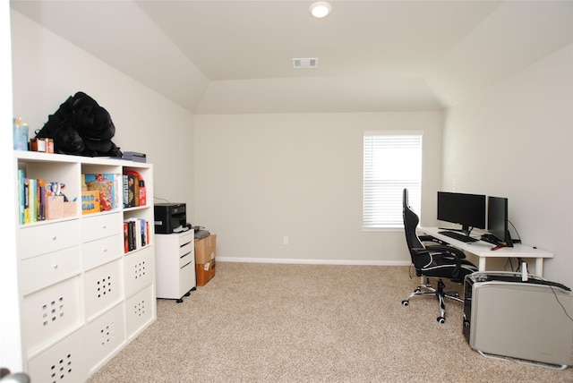 carpeted home office with lofted ceiling