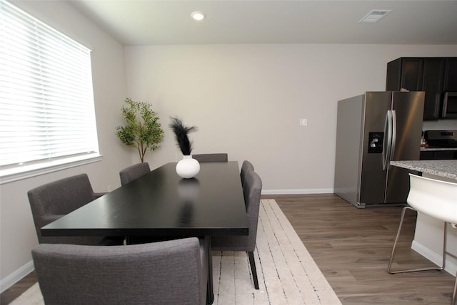 dining space with light hardwood / wood-style flooring