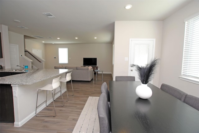 dining room with light wood-type flooring and sink