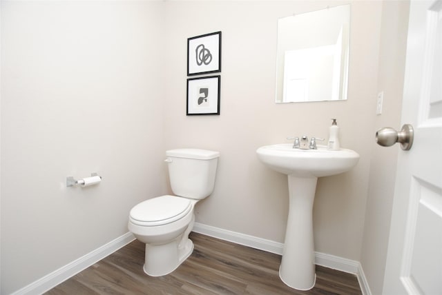 bathroom featuring hardwood / wood-style flooring and toilet