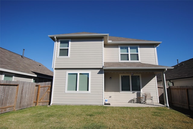 back of property featuring a patio area and a lawn