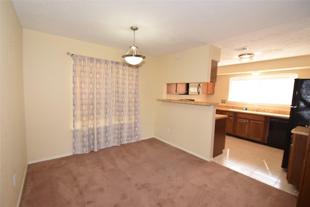 kitchen with light carpet, black appliances, and kitchen peninsula