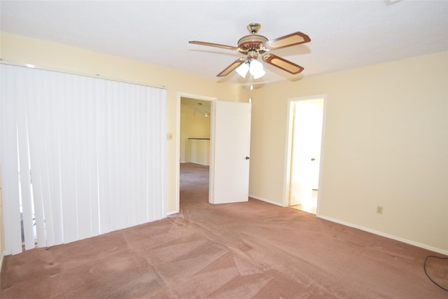 spare room featuring ceiling fan and light colored carpet