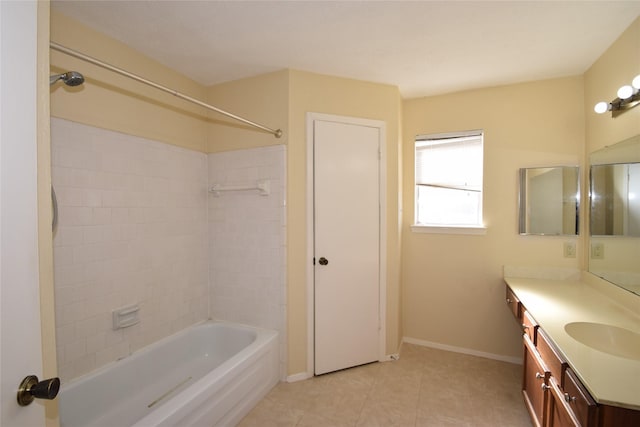 bathroom with tile patterned floors, tiled shower / bath, and vanity