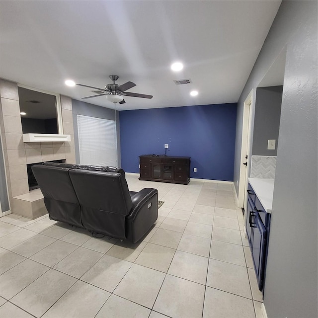 tiled living room with ceiling fan